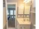 Well-lit bathroom featuring a vanity with storage and a view into the living room at 4823 Orchid Way # 2-203, Myrtle Beach, SC 29577