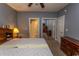 Cozy bedroom with ensuite bath featuring neutral walls and classic wood furniture at 4823 Orchid Way # 2-203, Myrtle Beach, SC 29577