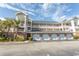 Beautiful condo building with private garages and balconies, perfect for beachside living at 4823 Orchid Way # 2-203, Myrtle Beach, SC 29577