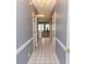 Inviting hallway with neutral paint and tile flooring offers a seamless transition to the living area at 4823 Orchid Way # 2-203, Myrtle Beach, SC 29577