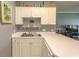 Bright kitchen featuring white countertops and cabinets overlooking a living area at 4823 Orchid Way # 2-203, Myrtle Beach, SC 29577