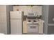 Well-equipped kitchen featuring white appliances, cabinets, and neutral decor at 4823 Orchid Way # 2-203, Myrtle Beach, SC 29577