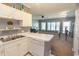 Open kitchen and living area with white countertops, cabinets, and modern appliances at 4823 Orchid Way # 2-203, Myrtle Beach, SC 29577