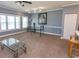 Spacious living room with natural light, stylish glass table, and a view into the rest of the condo at 4823 Orchid Way # 2-203, Myrtle Beach, SC 29577