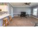 Cozy living room with neutral tones, a ceiling fan, breakfast bar, and a view into the kitchen at 4823 Orchid Way # 2-203, Myrtle Beach, SC 29577