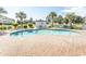 Outdoor swimming pool surrounded by lounge chairs, palm trees, and a pool house at 4823 Orchid Way # 2-203, Myrtle Beach, SC 29577