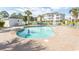 Outdoor pool with clear water, a paved deck, lounge chairs, and a pool house at 4823 Orchid Way # 2-203, Myrtle Beach, SC 29577