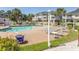 Outdoor swimming pool area with lounge chairs and a nearby apartment complex on a bright sunny day at 4823 Orchid Way # 2-203, Myrtle Beach, SC 29577