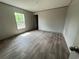 Bedroom with wood-look flooring, neutral walls, a window and an entry door at 491 N Green Sea Rd., Loris, SC 29569