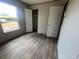 Bedroom featuring wood-look floors, a window with natural light, and a closet with an open door at 491 N Green Sea Rd., Loris, SC 29569