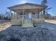 New construction home featuring a covered front porch with wooden decking and stairs at 491 N Green Sea Rd., Loris, SC 29569