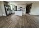 Bright kitchen featuring stainless steel appliances, white cabinets, an island, and wood-look flooring at 491 N Green Sea Rd., Loris, SC 29569