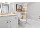 Cozy bathroom featuring a marble vanity top, framed heron art and a shower with striped curtain at 5000 Azul Loop, Myrtle Beach, SC 29579