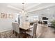 Elegant dining room with a chandelier, opening to a spacious living area and modern kitchen at 5000 Azul Loop, Myrtle Beach, SC 29579