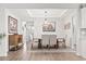Bright and airy dining room showcasing a tray ceiling, modern chandelier, and wood flooring at 5000 Azul Loop, Myrtle Beach, SC 29579