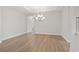 Spacious empty room with neutral walls, wood flooring, and modern lighting at 5000 Azul Loop, Myrtle Beach, SC 29579