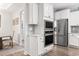 This kitchen features stainless appliances, white cabinets and an adjacent dining area at 5000 Azul Loop, Myrtle Beach, SC 29579