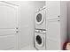 A modern laundry room with stacked Samsung washer and dryer, and a storage cabinet at 5000 Azul Loop, Myrtle Beach, SC 29579