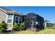 Outdoor screened porch, surrounded by green lawn and mature landscaping at 5000 Azul Loop, Myrtle Beach, SC 29579