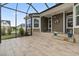 Covered patio featuring stone steps, potted plants, and backyard views through the screen at 5000 Azul Loop, Myrtle Beach, SC 29579