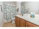 Well-lit bathroom showcasing a vanity with wooden cabinets, a clean white countertop, and a seashell-themed shower curtain at 541 Miromar Way, Myrtle Beach, SC 29588