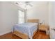 Cozy bedroom featuring hardwood floors, natural light, a wooden bed frame, and a bedside table at 541 Miromar Way, Myrtle Beach, SC 29588