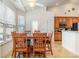 Sunlit dining area with a wooden table, six chairs, and large windows offering natural light and outdoor views at 541 Miromar Way, Myrtle Beach, SC 29588