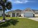 Charming single-story home with a well-manicured lawn, a palm tree, and an attached two-car garage at 541 Miromar Way, Myrtle Beach, SC 29588