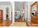 Open foyer featuring hardwood floors, arched doorways, and an antique coat rack for added charm at 541 Miromar Way, Myrtle Beach, SC 29588