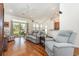 Comfortable living room showcasing hardwood floors, vaulted ceiling, and an open layout to kitchen at 541 Miromar Way, Myrtle Beach, SC 29588