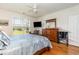 Well-lit main bedroom with wood floors, a large window, TV, dresser, and ample space for relaxation and comfort at 541 Miromar Way, Myrtle Beach, SC 29588