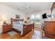 Inviting main bedroom with wood floors, a comfortable bed, dresser, window, and TV for relaxation and comfort at 541 Miromar Way, Myrtle Beach, SC 29588