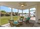Relaxing screened porch features wicker furniture and ceiling fan overlooking the landscaped backyard at 541 Miromar Way, Myrtle Beach, SC 29588