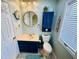 Charming bathroom featuring blue vanity, nautical decorations, and a round mirror to create a relaxing space at 6001 - 1599 S Kings Hwy., Myrtle Beach, SC 29575