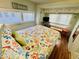 Bright bedroom with sea themed bedding, natural lighting, and a compact furniture arrangement at 6001 - 1599 S Kings Hwy., Myrtle Beach, SC 29575