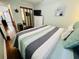 Bedroom with striped bedspread, mirrored closet, dresser, and TV that create a cozy and functional space at 6001 - 1599 S Kings Hwy., Myrtle Beach, SC 29575