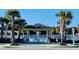 Welcoming waterpark entrance featuring palm trees, a decorative sign, and white picket fence at 6001 - 1599 S Kings Hwy., Myrtle Beach, SC 29575