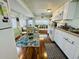 Bright kitchen with dining area, white cabinets, and modern appliances that create an open functional space at 6001 - 1599 S Kings Hwy., Myrtle Beach, SC 29575