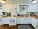 Bright kitchen featuring white cabinets, countertops, and modern appliances creating a clean, functional space at 6001 - 1599 S Kings Hwy., Myrtle Beach, SC 29575