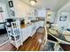 A kitchen and dining area features white appliances and wood flooring at 6001 - 1599 S Kings Hwy., Myrtle Beach, SC 29575