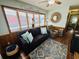 Cozy living room with wood paneling, a comfortable sofa, and natural light at 6001 - 1599 S Kings Hwy., Myrtle Beach, SC 29575