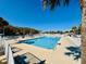 Relaxing poolside view featuring a large pool, surrounding lounge chairs, and mature palms at 6001 - 1599 S Kings Hwy., Myrtle Beach, SC 29575