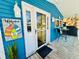 Inviting porch with a welcome sign, front door and outdoor table set at 6001 - 1599 S Kings Hwy., Myrtle Beach, SC 29575