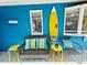 Vibrant porch with surfboard decor and cozy rattan seating at 6001 - 1599 S Kings Hwy., Myrtle Beach, SC 29575