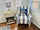 An armchair and side table are next to a bright window in this reading nook at 6001 - 1599 S Kings Hwy., Myrtle Beach, SC 29575