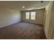 Neutral bedroom with plush carpet and a view to the backyard at 623 Muster Field Ct., Conway, SC 29526