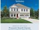 Charming two-story home with landscaped yard and a classic architectural style, offering a welcoming curb appeal at 6775 Genesis Dr, Murrells Inlet, SC 29576