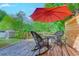 Outdoor deck with seating and a bright red umbrella at 834 Holly Sands Blvd., Little River, SC 29566