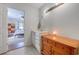 Bathroom with a vanity, a lighted mirror, a decorative cabinet, and a glimpse of the bedroom at 834 Holly Sands Blvd., Little River, SC 29566