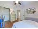 Bright bedroom with hardwood floors, closet, ensuite bathroom, and stylish geometric mirror at 834 Holly Sands Blvd., Little River, SC 29566